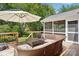 Spacious back deck with outdoor seating, an umbrella and views of the yard at 3918 Rea Rd, Charlotte, NC 28226