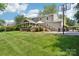 View of the back of the house showing the deck, patio and basketball court at 3918 Rea Rd, Charlotte, NC 28226