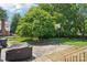 Spacious backyard featuring a basketball court and lush greenery at 3918 Rea Rd, Charlotte, NC 28226