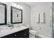 Bathroom with double vanity, marble countertop, black fixtures, and black framed mirrors at 3918 Rea Rd, Charlotte, NC 28226
