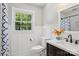 Bathroom with wainscoting, custom vanity, and a large window to let in natural light at 3918 Rea Rd, Charlotte, NC 28226