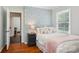 Bedroom with decorative wallpaper, hardwood floors, and a window overlooking the backyard at 3918 Rea Rd, Charlotte, NC 28226
