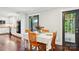 Dining area with hardwood floors, a table set for four, and a view into a modern kitchen at 3918 Rea Rd, Charlotte, NC 28226