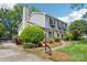 Angle view of a home with a brick and gray siding exterior, complemented by a landscaped yard and garden at 3918 Rea Rd, Charlotte, NC 28226