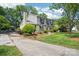 View of a two-story house with a brick chimney, gray siding, and a long driveway leading to the property at 3918 Rea Rd, Charlotte, NC 28226