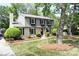 Charming two-story home with gray and brick exterior, manicured lawn, and mature trees at 3918 Rea Rd, Charlotte, NC 28226
