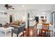 An open-concept living space with hardwood floors, modern furniture, and a view into the bright, white kitchen at 3918 Rea Rd, Charlotte, NC 28226