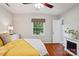 Comfortable main bedroom with hardwood floors, a decorative fireplace, and natural light creates a serene retreat at 3918 Rea Rd, Charlotte, NC 28226