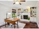 Home office features a working fireplace, built-in bookshelves, and a hardwood floor, for focused work at 3918 Rea Rd, Charlotte, NC 28226