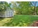 Storage shed with a swing in the lush, shady backyard at 3918 Rea Rd, Charlotte, NC 28226