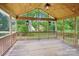 Covered outdoor porch features wood floors, a ceiling fan, and string lights at 3918 Rea Rd, Charlotte, NC 28226