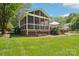 Well-maintained screened porch featuring string lights and an attached deck for outdoor relaxation at 3918 Rea Rd, Charlotte, NC 28226
