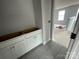 View of an unfinished bathroom with gray tile floors and white cabinets with a view of another room at 4021 Grommet Ct, Matthews, NC 28105