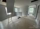 Large bonus room upstairs with multiple windows, offering ample natural light and versatility for various uses at 4021 Grommet Ct, Matthews, NC 28105