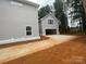 New home with a detached two-car garage featuring a spacious driveway for additional parking at 4021 Grommet Ct, Matthews, NC 28105