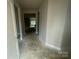 Hallway with neutral paint, white trim and doors leading to other rooms in the home, showcasing the open floor plan at 4021 Grommet Ct, Matthews, NC 28105