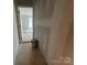 Hallway with view to a bedroom with three windows, offering ample natural light at 4021 Grommet Ct, Matthews, NC 28105
