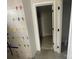 Hallway with adjacent bathroom featuring new tiling and a doorway to another room at 4021 Grommet Ct # 4, Matthews, NC 28105