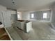 Kitchen area with white cabinetry and a center island, blending style and functionality in the open layout at 4021 Grommet Ct, Matthews, NC 28105
