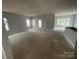 Bright living room featuring an open floor plan and multiple windows, creating a spacious and inviting atmosphere at 4021 Grommet Ct # 4, Matthews, NC 28105