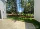 View of the backyard featuring a concrete patio, and plenty of mature trees at 4021 Grommet Ct, Matthews, NC 28105