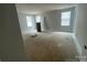 Bright bedroom with large windows offering ample natural light, neutral walls, and space for customization at 4021 Grommet Ct, Matthews, NC 28105