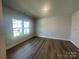 Bedroom featuring wood-look flooring, a neutral paint, and natural light at 4021 Grommet Ct, Matthews, NC 28105