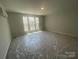 A bright bedroom with large windows, offering natural light and scenic views, creating a relaxing and inviting space at 4021 Grommet Ct, Matthews, NC 28105