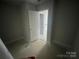 Unfinished bedroom displaying the blank slate for customization, with doorway leading into the next room at 4021 Grommet Ct, Matthews, NC 28105