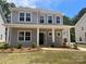 Charming two-story home featuring a welcoming front porch with classic columns and fresh landscaping at 4021 Grommet Ct, Matthews, NC 28105