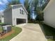 Detached gray garage featuring a concrete driveway, window, siding and a peek of the trees at 4021 Grommet Ct, Matthews, NC 28105