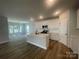 Kitchen and living area featuring an island, stainless appliances and white cabinets at 4021 Grommet Ct, Matthews, NC 28105