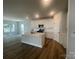 Kitchen and living area featuring an island, stainless appliances and white cabinets at 4021 Grommet Ct, Matthews, NC 28105