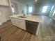 Kitchen island with stainless steel dishwasher, sink, faucet, and marble countertop at 4021 Grommet Ct, Matthews, NC 28105