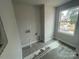 Well-lit laundry room with modern gray tiling and a window at 4021 Grommet Ct, Matthews, NC 28105