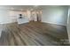 Open-concept living room and kitchen with stainless steel appliances and hardwood floors at 4021 Grommet Ct, Matthews, NC 28105