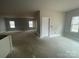 Large, bright living room area with lots of natural light, ready for flooring at 4021 Grommet Ct, Matthews, NC 28105