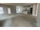 Bright living space with an open floor plan leads to the kitchen with white cabinets and a center island at 4021 Grommet Ct, Matthews, NC 28105