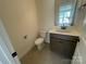 A clean half-bathroom featuring neutral colors, offering a simple and functional space at 4025 Grommet Ct, Matthews, NC 28105