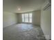 A spacious bedroom featuring ample natural light and carpeted floors ready for personalization at 4025 Grommet Ct, Matthews, NC 28105