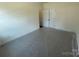 Unfurnished bedroom with carpet and white double doors to a closet space at 4025 Grommet Ct, Matthews, NC 28105