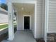 Inviting front porch with white pillars, displaying the house number and a glimpse inside the home at 4025 Grommet Ct, Matthews, NC 28105