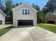 Detached two-car garage exterior with modern design and driveway, enhancing curb appeal and functionality at 4025 Grommet Ct, Matthews, NC 28105