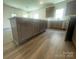 Open kitchen with stainless steel appliances, spacious island, and wooden flooring at 4025 Grommet Ct, Matthews, NC 28105