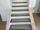 A staircase is prepped for hardwood treads and white risers, ready for the finishing touches at 4025 Grommet Ct, Matthews, NC 28105