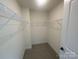 Spacious walk-in closet features neutral walls, carpeted floor, and metal shelving, offering ample storage at 4025 Grommet Ct, Matthews, NC 28105