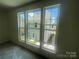 A view from a room with three large windows showcasing the exterior neighborhood and plenty of natural light at 4025 Grommet Ct, Matthews, NC 28105