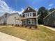 Attractive two-story home features a welcoming covered porch with beautiful landscaping at 4029 Grommet Ct, Matthews, NC 28105