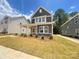 Attractive two-story home features a welcoming covered porch with beautiful landscaping at 4029 Grommet Ct, Matthews, NC 28105