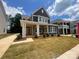 Charming two-story home with a welcoming covered porch and beautifully landscaped front yard at 4029 Grommet Ct, Matthews, NC 28105